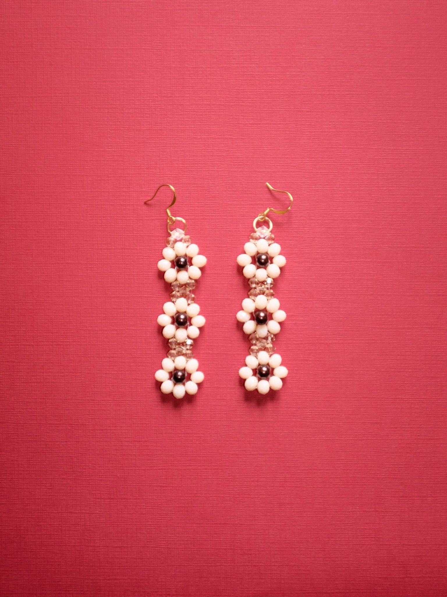 “Close-up of Marguerite II handmade floral earrings in silver and gold with peach and brown beads