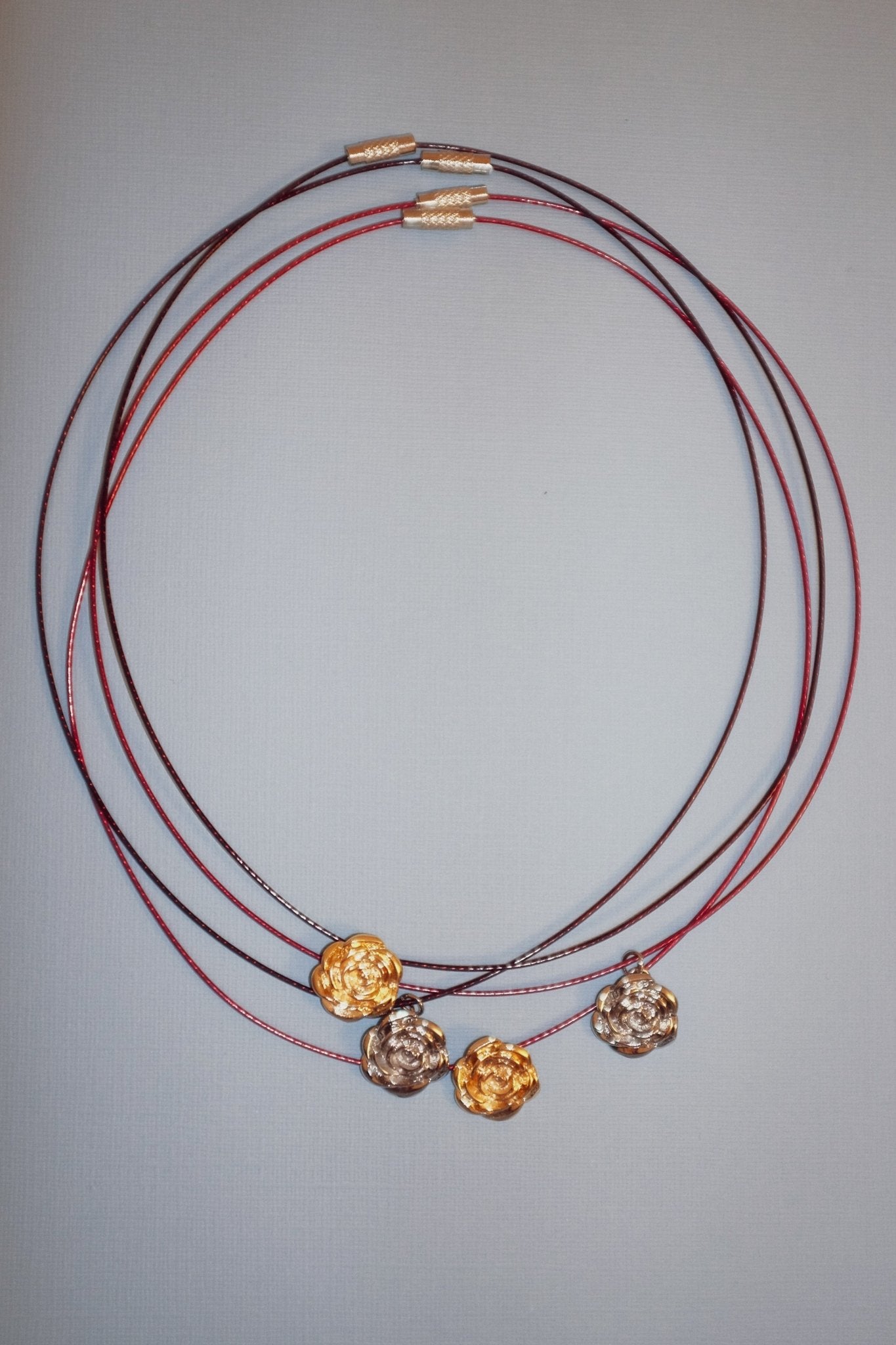 Gold and platinum plated rose charm necklace on stainless steel wire – Blóma