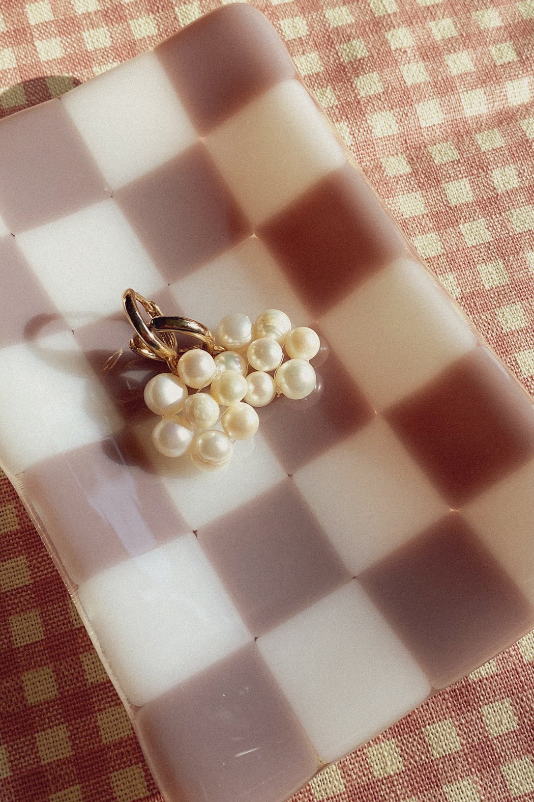 Handmade pearl flower charm hoops in gold finish, Blóma jewellery flatlay