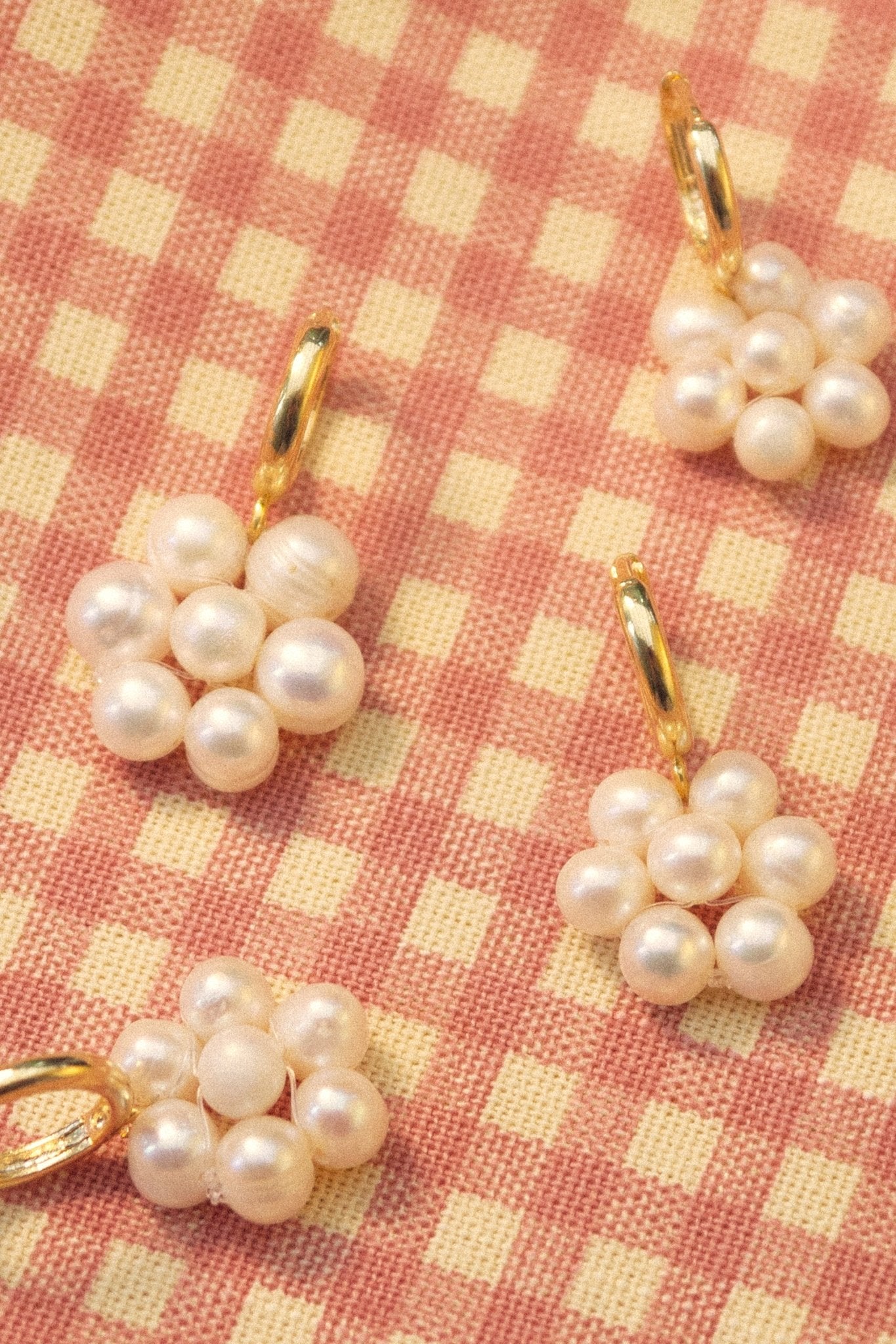 Handmade pearl flower charm hoops in gold finish, Blóma jewellery flatlay
