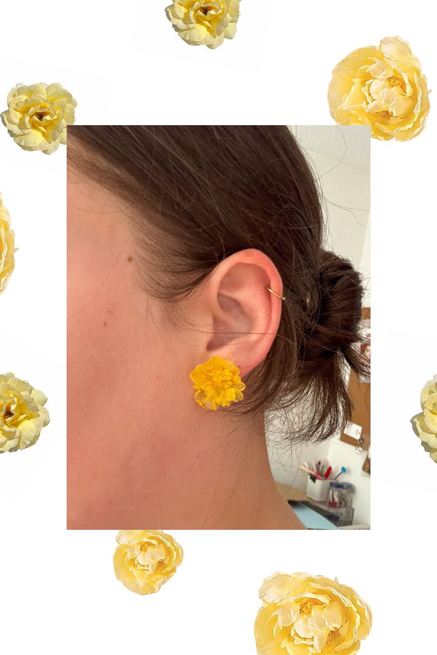 Close-up of an ear wearing a yellow floral earring with decorative yellow flowers around the image.